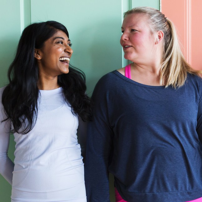 Two people in activewear laughing